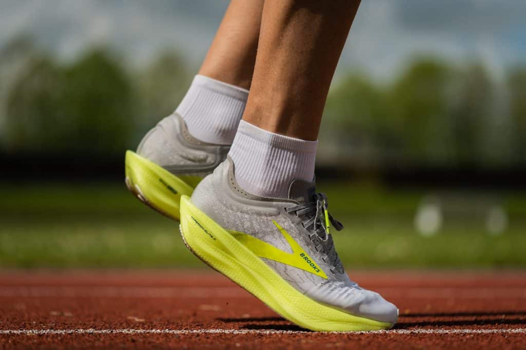 person wearing yellow and white nike athletic shoes